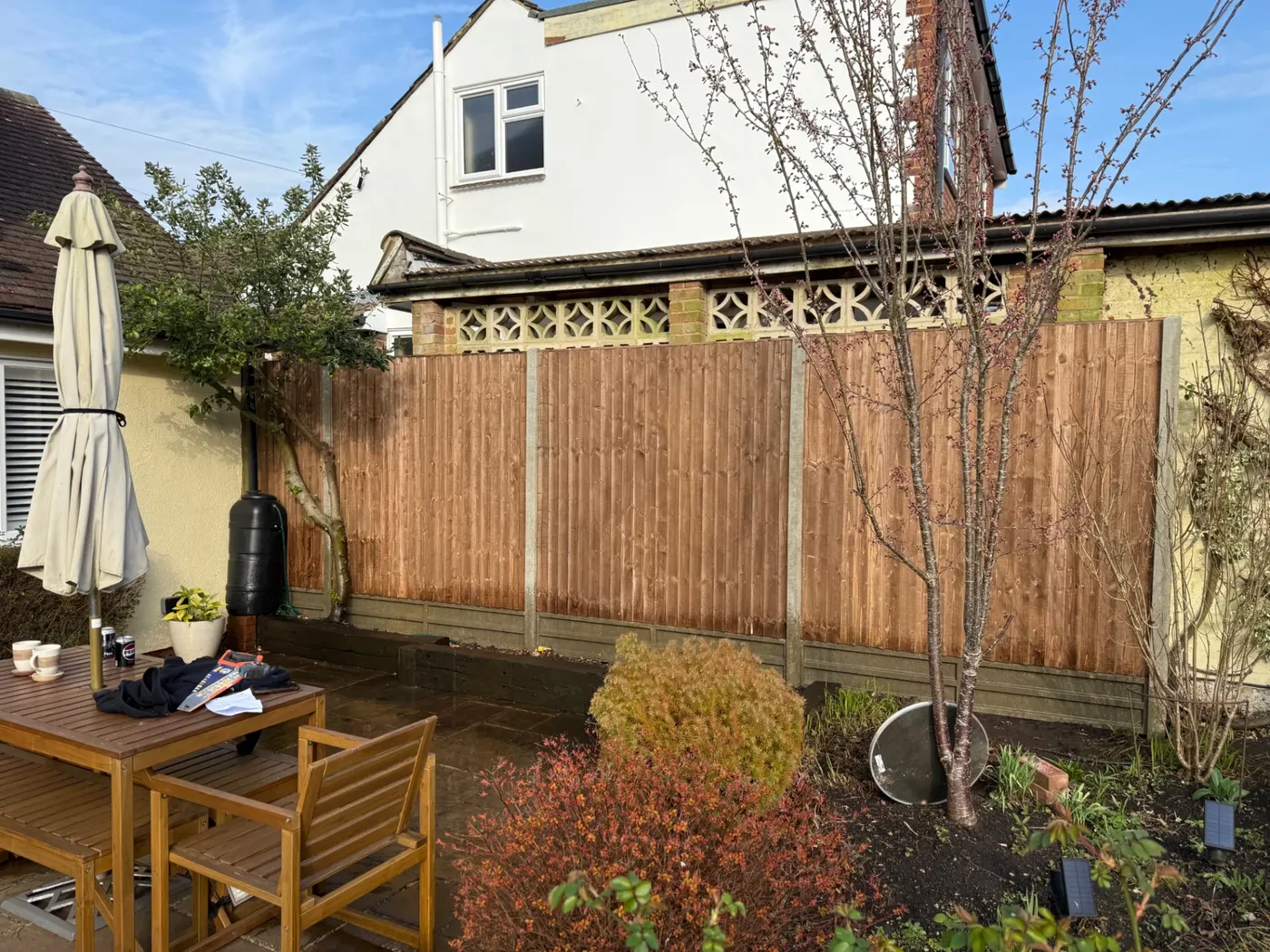 Brown feather edge fence panels behind a patio