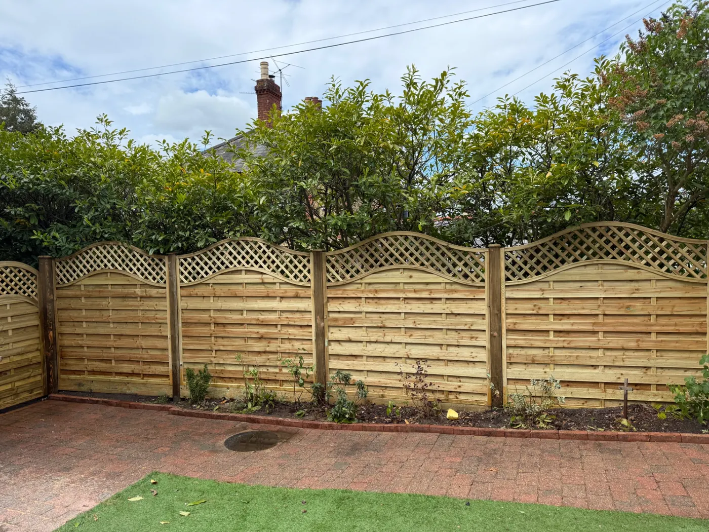 Continental style trellis top fencing in a back garden