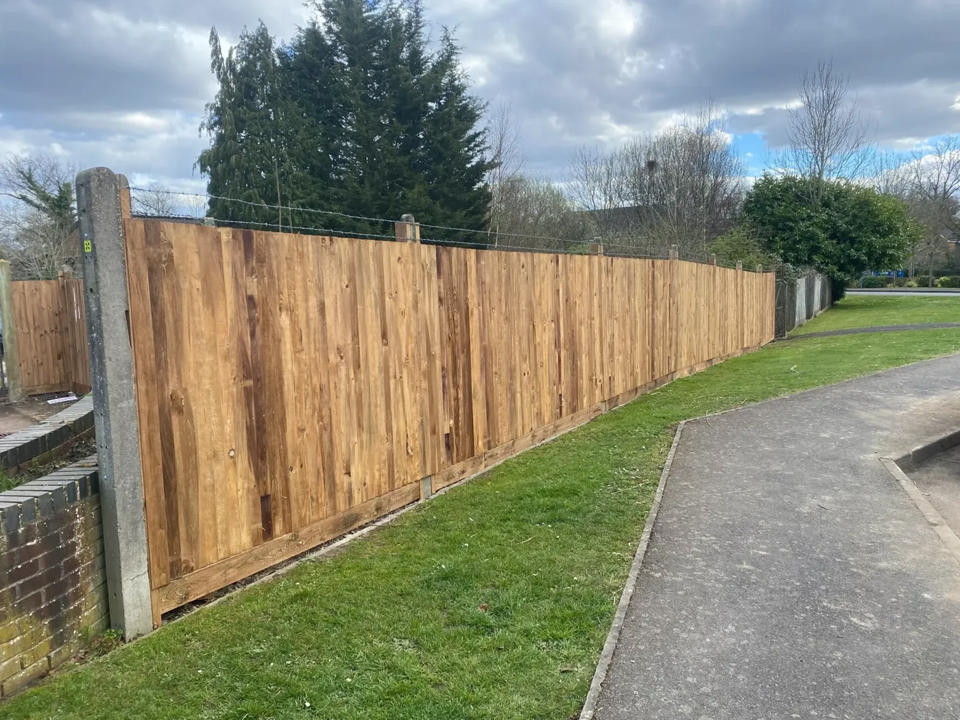 Closeboard fencing with timber posts along a rear boundary