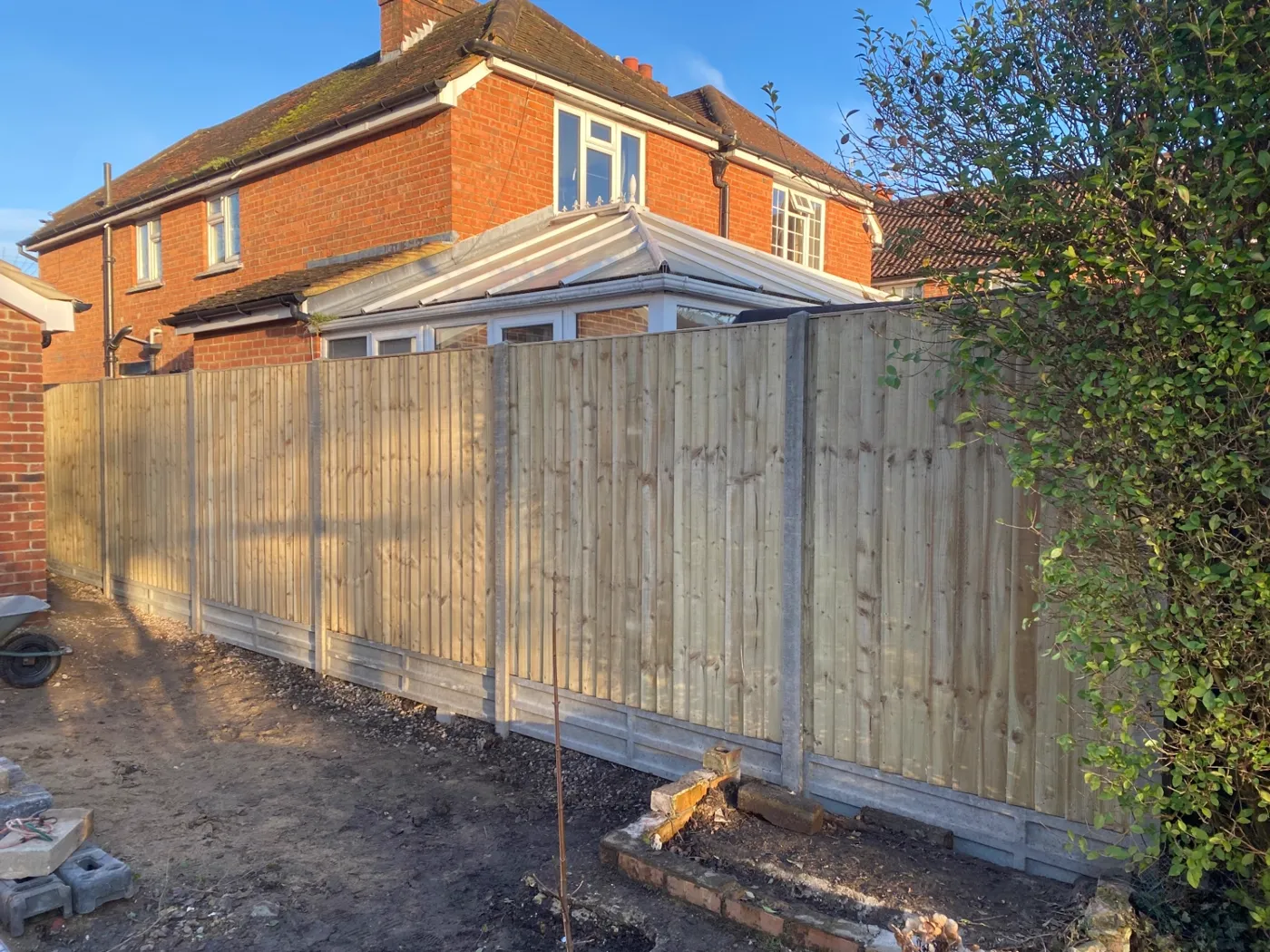 New closeboard garden fence with concrete posts and gravel boards in a Guildford garden